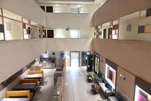 an overhead view of a building with tables and chairs at Hotel Express Airoli in Navi Mumbai