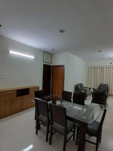 a living room with a dining room table and chairs at Chiakunja in Dhaka