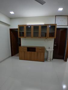 an empty room with wooden cabinets and a toilet at Chiakunja in Dhaka +4 photos