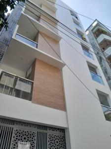 an exterior view of a white building with windows at Chiakunja in Dhaka