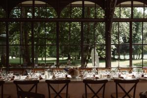 a long table in a large room with windows at ABBAYE DE BLANCHELANDE in Neufmesnil
