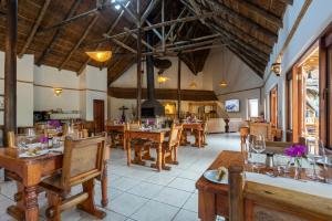 a dining room with wooden tables and chairs at Elephants Footprint Lodge in Colchester