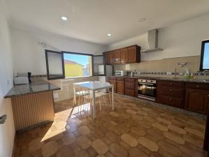 a kitchen with a table and a counter top at Peniche Surf & Sunset House in Peniche