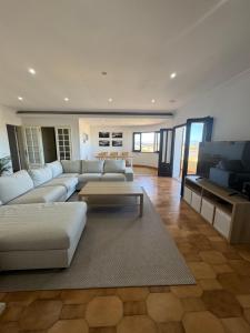 a large living room with a couch and a table at Peniche Surf & Sunset House in Peniche