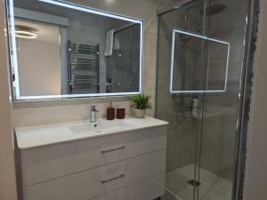 a bathroom with a sink and a shower at Apartaments IXA in Manresa +57 photos