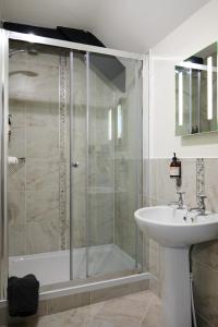 a bathroom with a shower and a sink at Reddivallen Farmhouse in Boscastle +11 photos