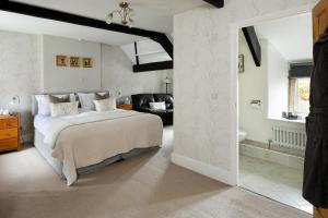 a bedroom with a large bed and a living room at Reddivallen Farmhouse in Boscastle