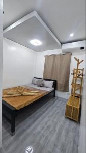 a room with a bed in a room with a ladder at Fab's Spot El Nido in El Nido