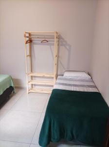 a small bedroom with a bed and a ladder at Casa da Simonia in Foz do Iguaçu