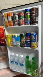 a refrigerator filled with lots of drinks and drinks at Homestay Sani in Tanah Merah +13 photos