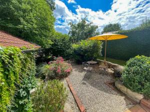 a patio with a table and an umbrella at Villa With Split-Level Architecture By Ammersee in Hechenwang