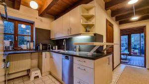 a kitchen with white cabinets and a counter top at Villa With Split-Level Architecture By Ammersee in Hechenwang