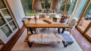 a dining room with a table and some chairs at Villa With Split-Level Architecture By Ammersee in Hechenwang +24 photos