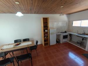a kitchen and dining room with a table and chairs at LaLeLa in Gualeguaychú