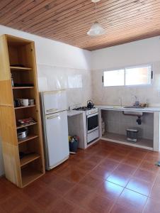 a kitchen with a white refrigerator and a sink at LaLeLa in Gualeguaychú
