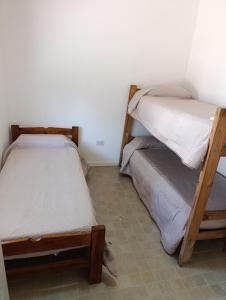 two bunk beds in a room with a tiled floor at LaLeLa in Gualeguaychú