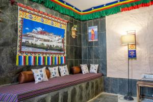 a bed in a room with a painting on the wall at Mud House Entire Cottage in Dharmsāla