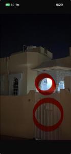 a red circle is on the side of a building at Elite Apartment in Nizwa