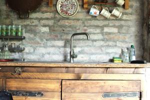 a kitchen with a sink and a brick wall at Hámori Álom in Miskolc +59 photos