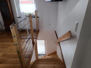 a spiral staircase in a room with a window at Kastanienhof Lübben in Lübben