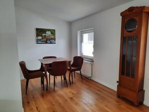a dining room with a table and chairs and a window at Kastanienhof Lübben in Lübben