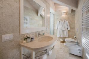a bathroom with a sink and a toilet at Villa Lilla sulla Spiaggia di San Vincenzo LUXURY in San Vincenzo +50 photos