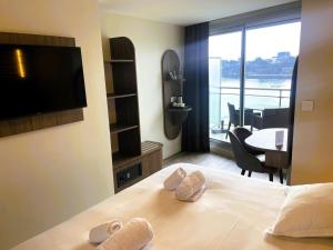 a hotel room with a bed with a flat screen tv at Best Western Hotel Le Crystal Dinard in Dinard