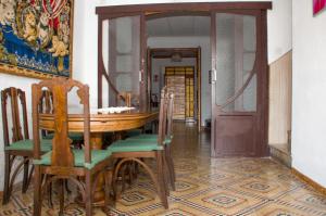 a dining room with a wooden table and chairs at Casa Marifina in Enguera