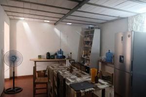 a room with a table and a refrigerator at La mansion caballero hostal in Asunción