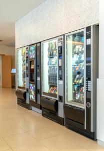 a row of slot machines in a shopping mall at Park Hotel Porto Aeroporto in Maia