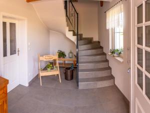 a staircase in a house with a table and a chair at Ferienwohnung Spreewaldglück in Burg