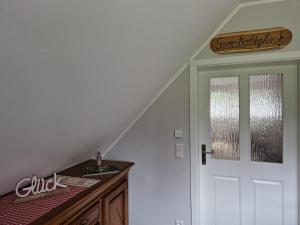 a staircase with a white door and a window at Ferienwohnung Spreewaldglück in Burg +21 photos