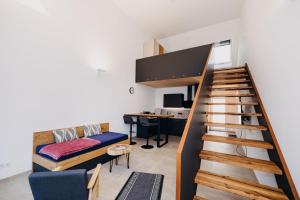 a living room with a staircase and a desk at Mühlenhof Franken in Kirchheim