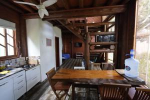 a kitchen with a wooden table with a bottle of water on it at Casa alquiler en Bombas Bombinhas in Bombas +33 photos