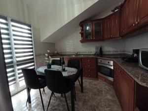 a kitchen with a table and chairs in it at Charm Penthouse Ocean View in Calheta