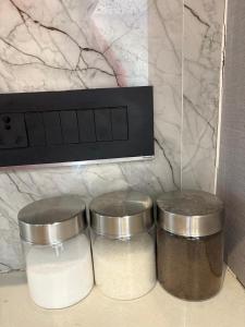 two containers of food sitting on a counter next to a microwave at Hotel Namaste With Jacuzzi in Ghaziabad