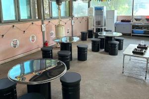 a room with a row of tables and trash cans at Glamdog - Gapyeong in Gapyeong