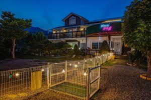 a fence in front of a house with lights at Glamdog - Gapyeong in Gapyeong +44 photos