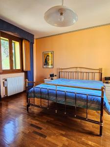 a bedroom with a bed with a blue comforter at Il Glicine in Làconi