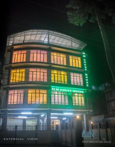 a building with lit up windows at night at HN Guest House in Shillong