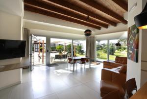 a living room with a tv and a couch and a table at Ferrocino Resort in Galatone