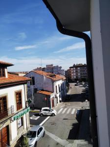 a view from a window of a city street at La CASINA de HUGO con Terraza in Luanco +16 photos