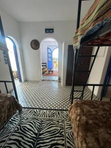 a room with two bunk beds and a hallway at Rhythm House in Essaouira