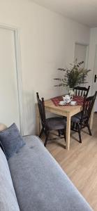 a dining room table with chairs and a table with at Domki u Sołtysa in Ciechocinek