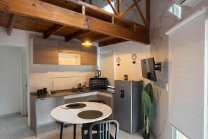 a small kitchen with a table and a refrigerator at Ana rent Ballester departamentos modernos luminosos, equipados para una hermosa estadia in Villa Ballester