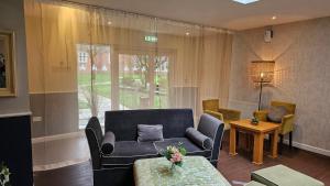 a living room with a couch and a table at Muthu Clumber Park Hotel and Spa in Worksop