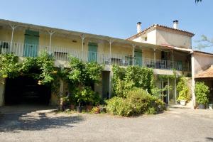 an old building with plants on the side of it at Le Mas Cauvy in Saint-Christol-lès-Alès