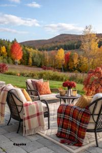 a patio with chairs and a table with a view of trees at Görbe Vendégház in Tarcal