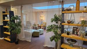 a living room with potted plants on shelves at Muthu Clumber Park Hotel and Spa in Worksop