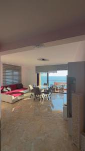 a living room with a bed and a table and chairs at Bella Costa Lux in Dobra Voda